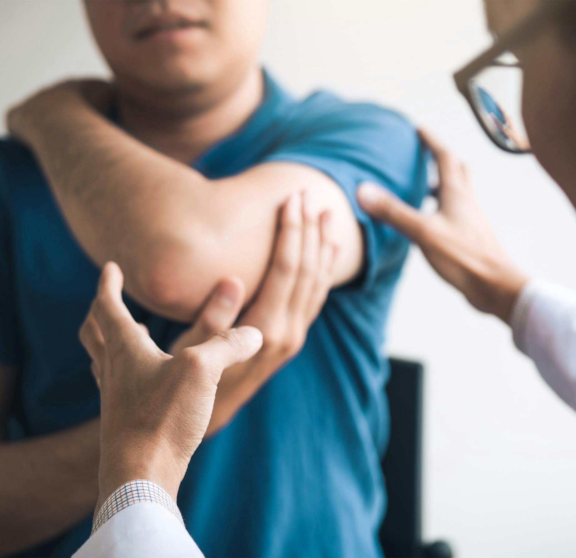 doctor looking at a patient's arm