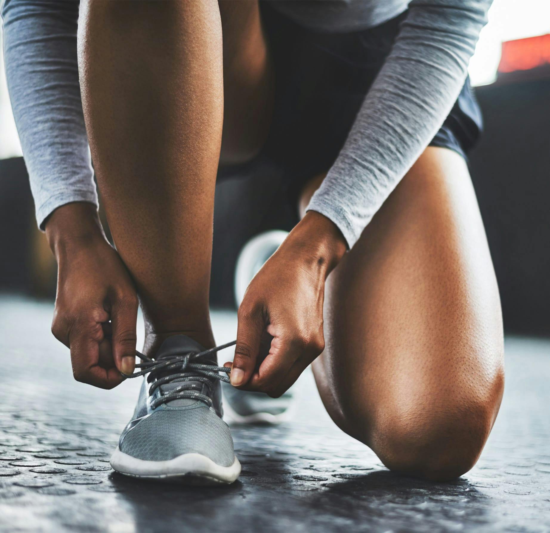 woman tying her shoes
