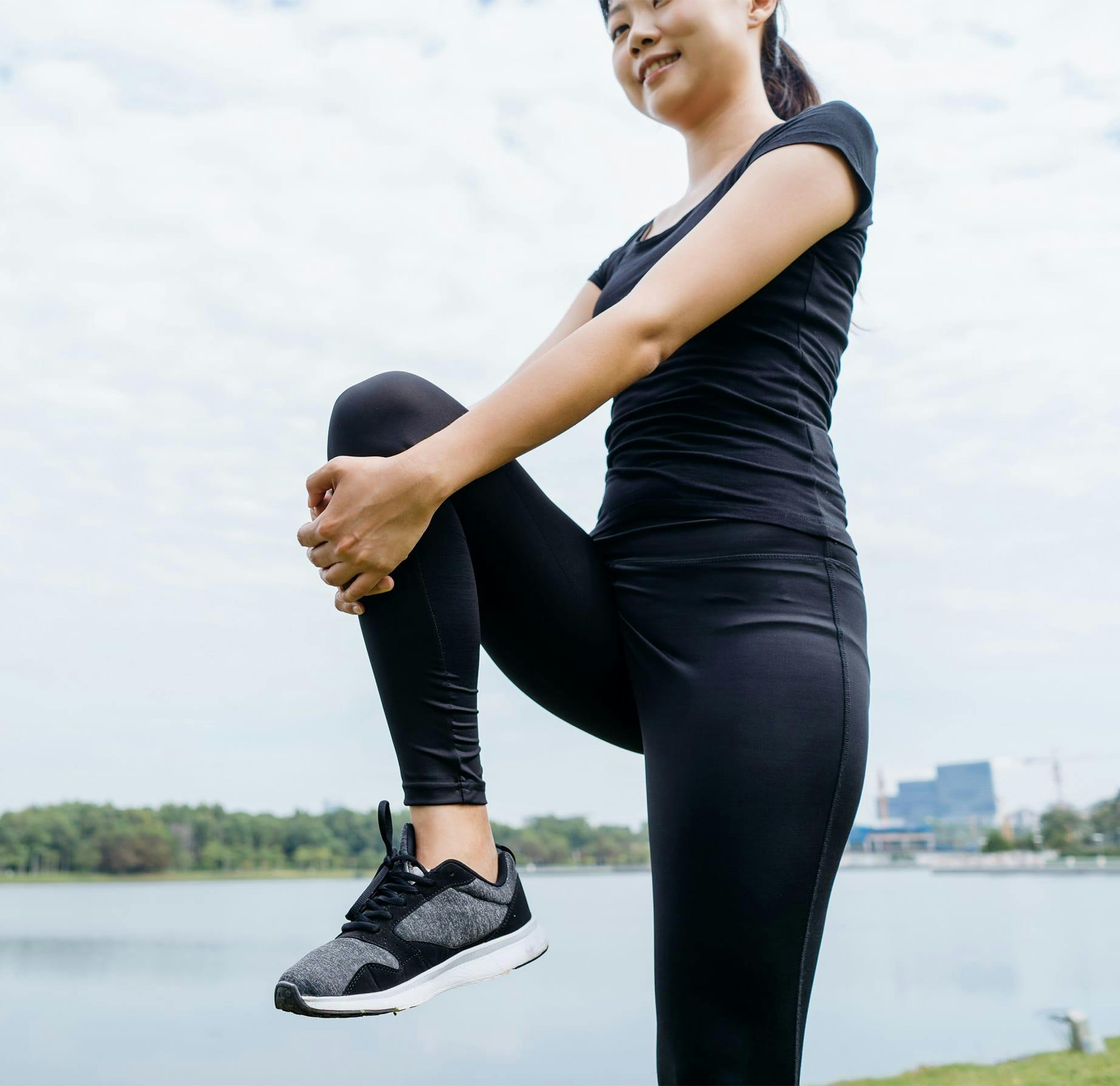woman holding her knee