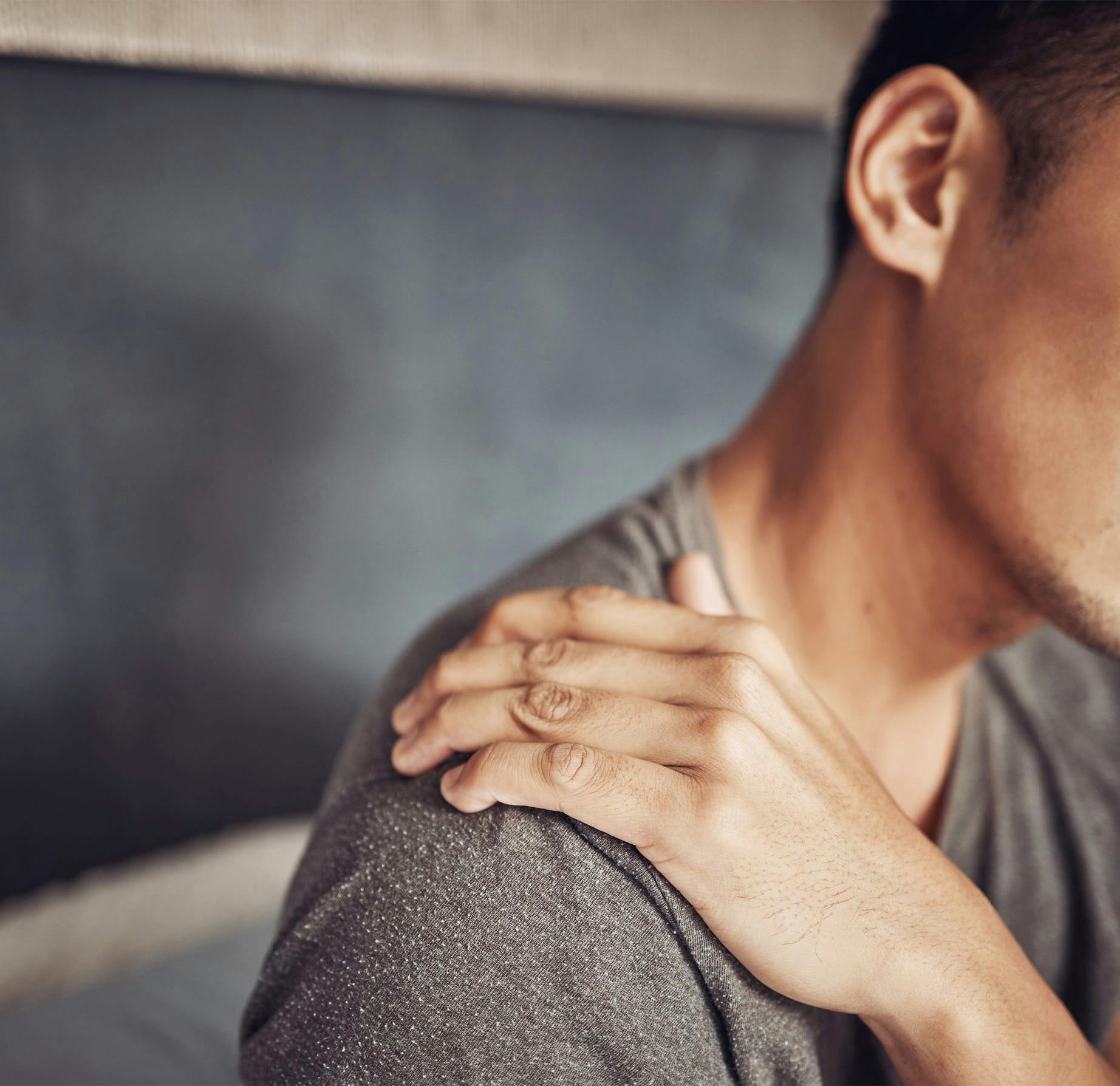 man holding his shoulder