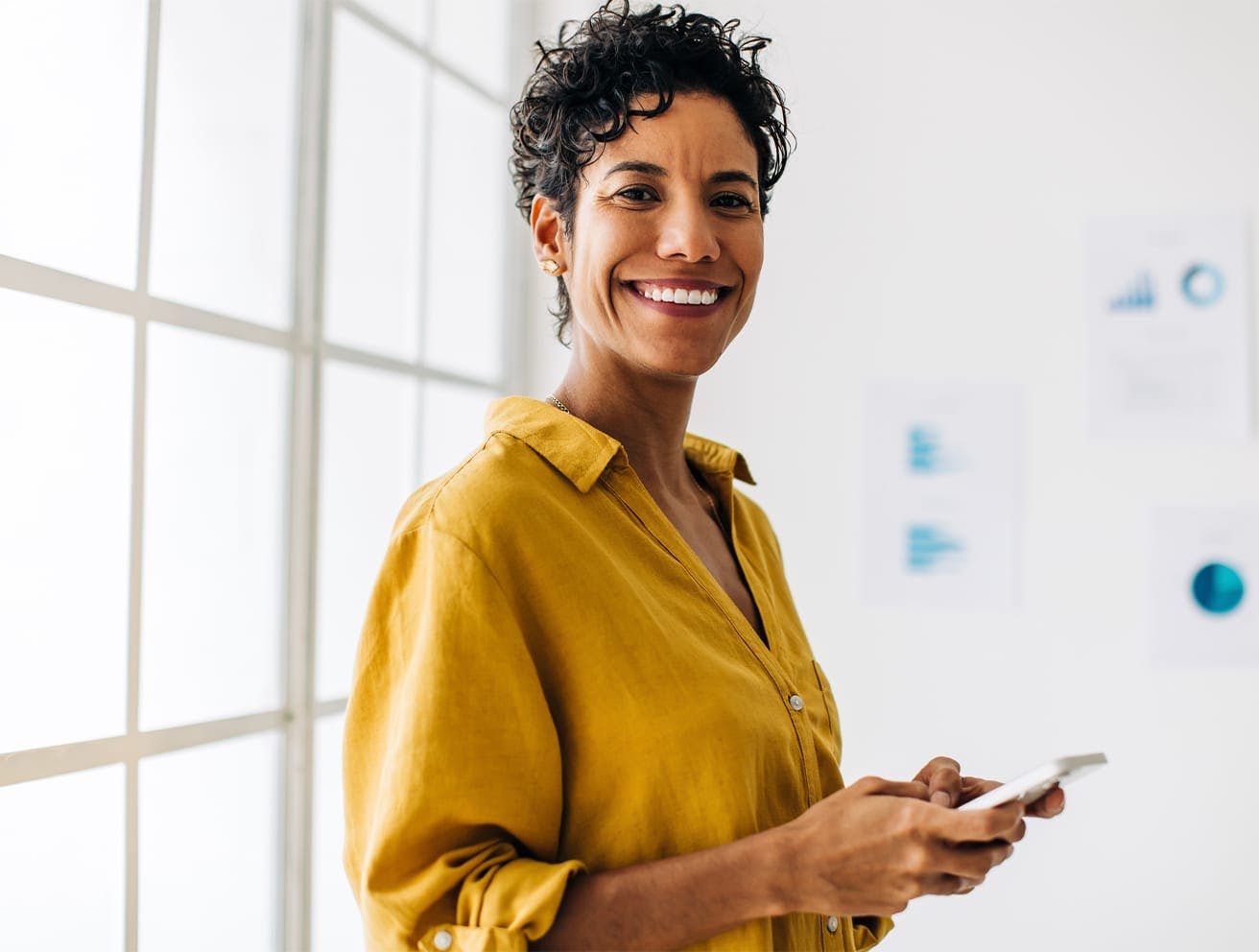 woman holding a phone smiling'