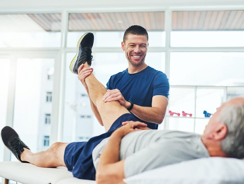 man holding up a patient's leg