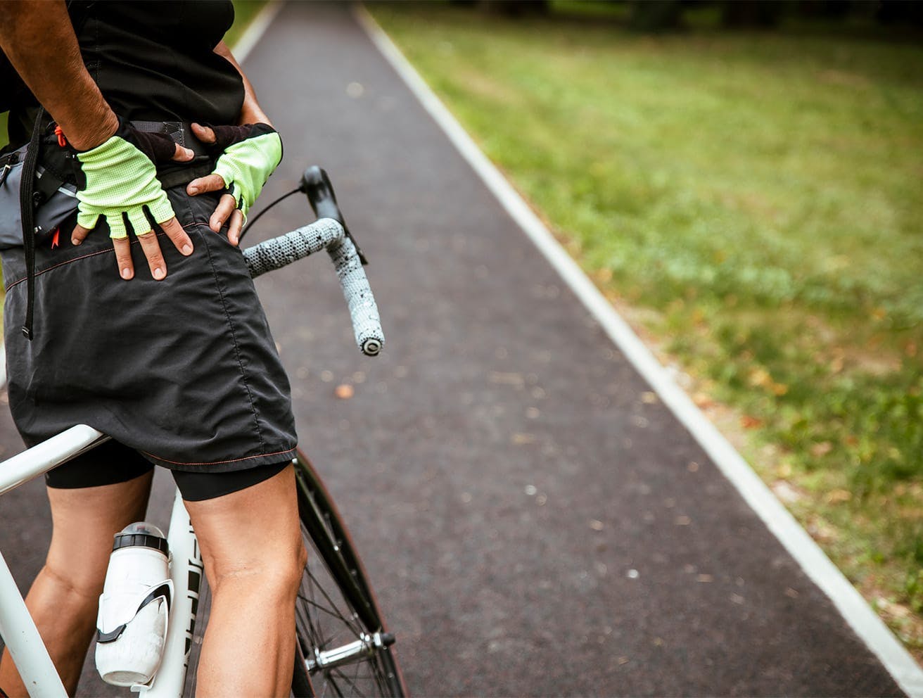 man on a bike holding his hip