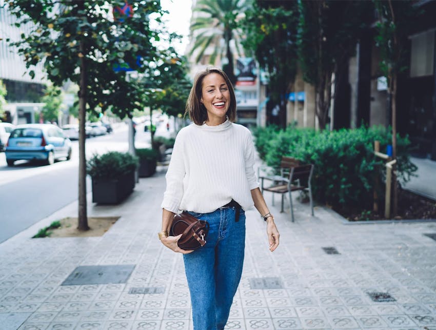 woman walking down a sidewalk