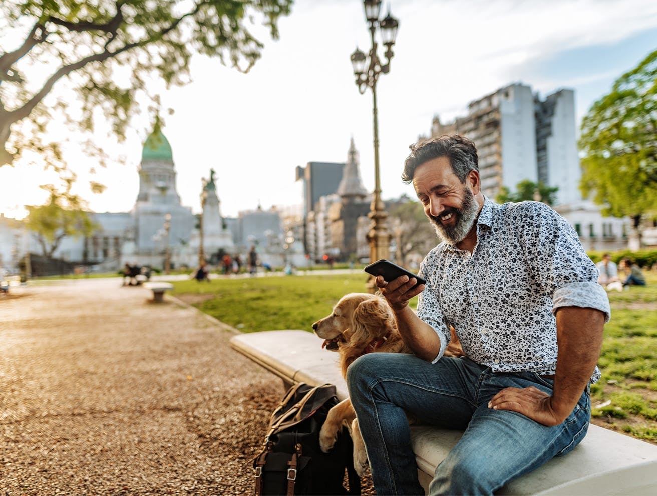 man sitting on a bench with a dog