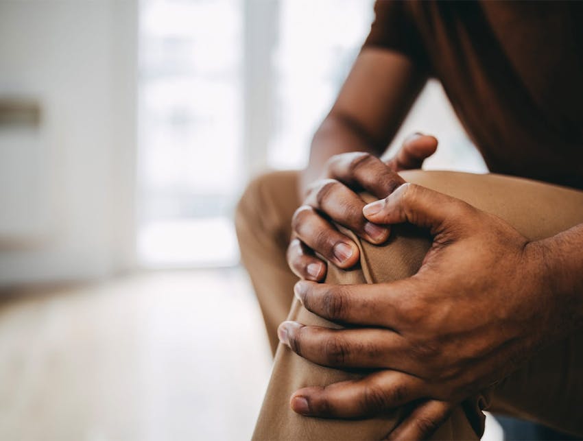 man holding his knee