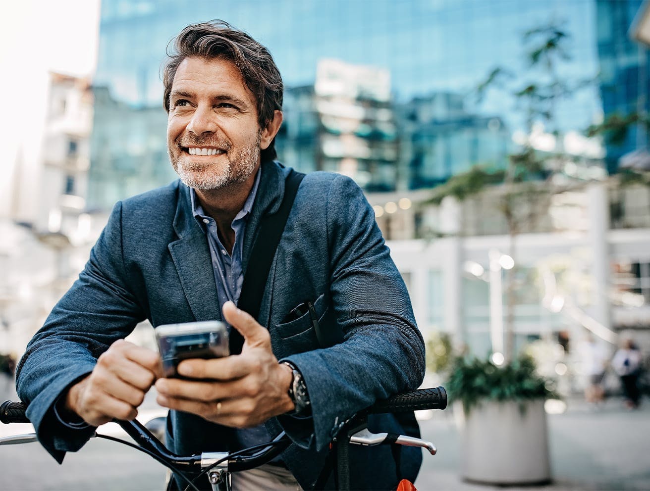 man on a bike holding phone
