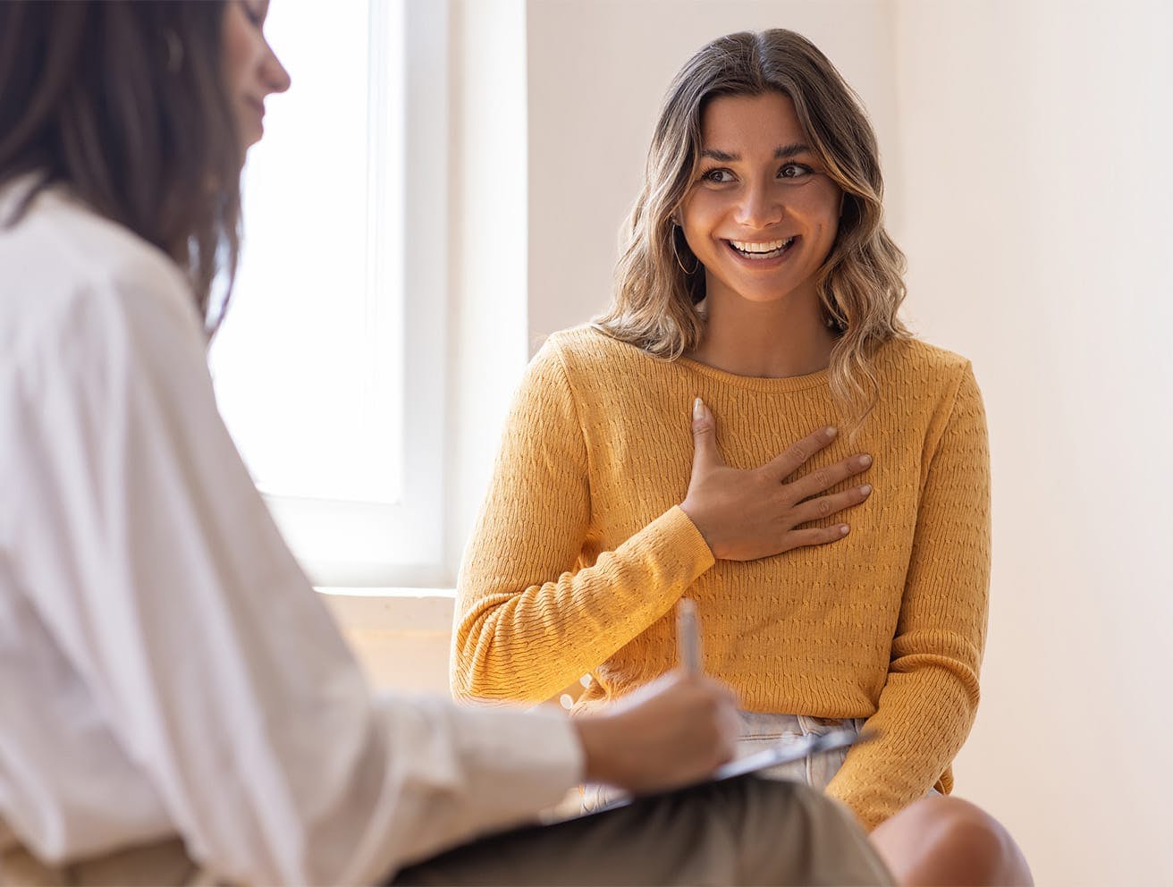 woman smiling touching her chest