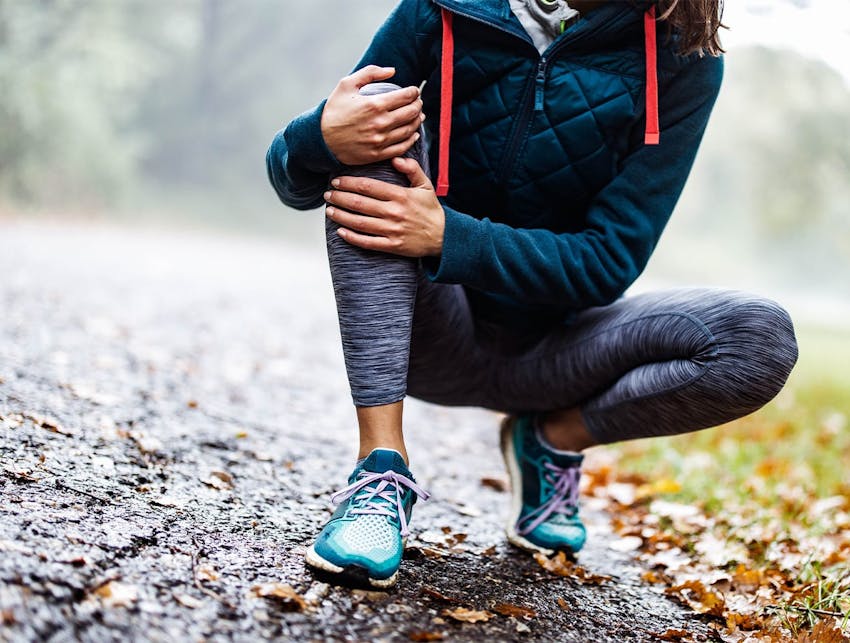 woman holding her knee