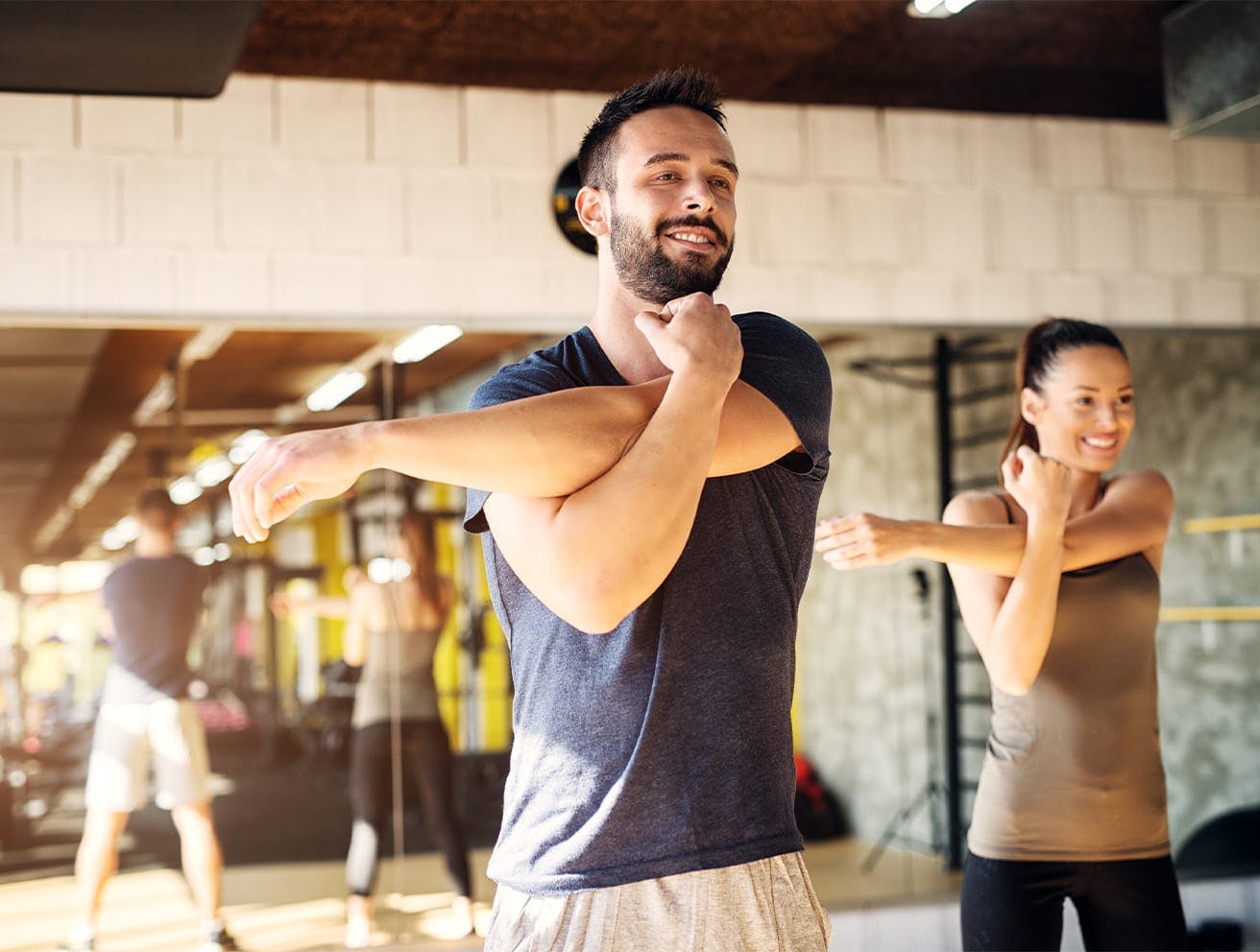 man and woman stretching their arms