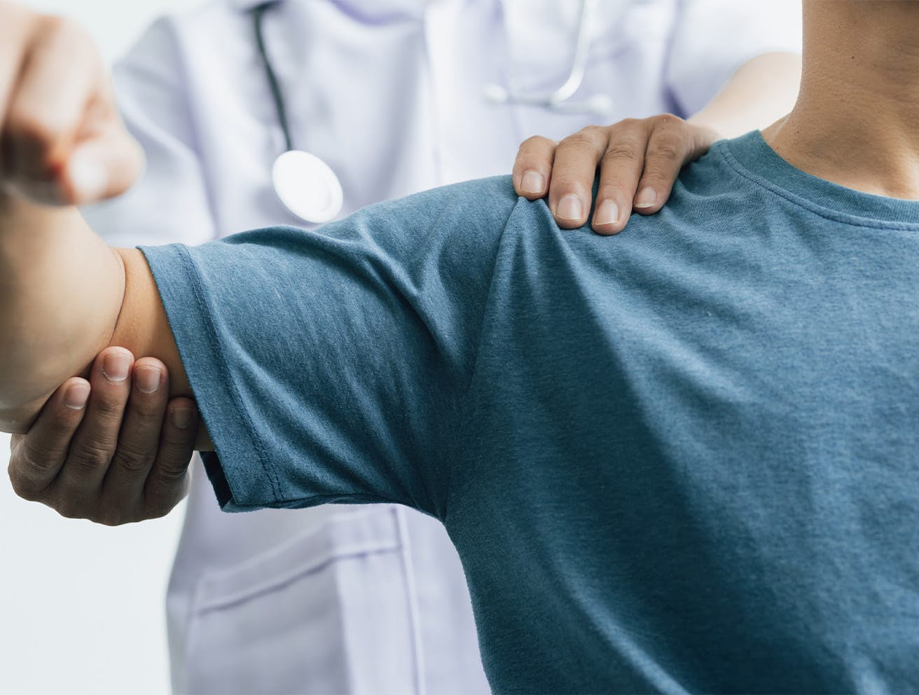 doctor lifting a patient's arm