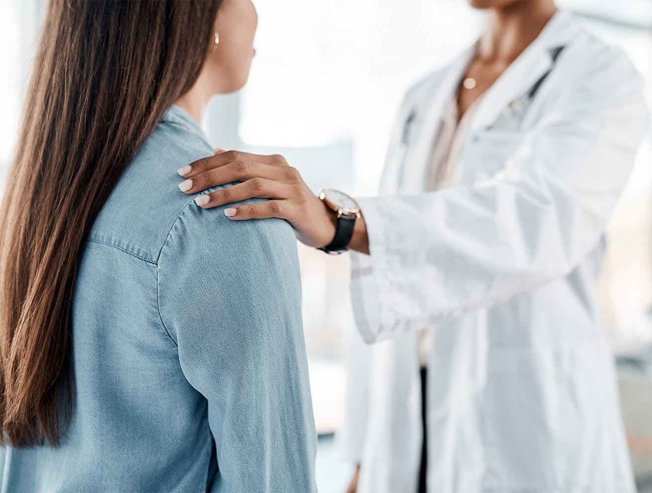 doctor touching patient's shoulder