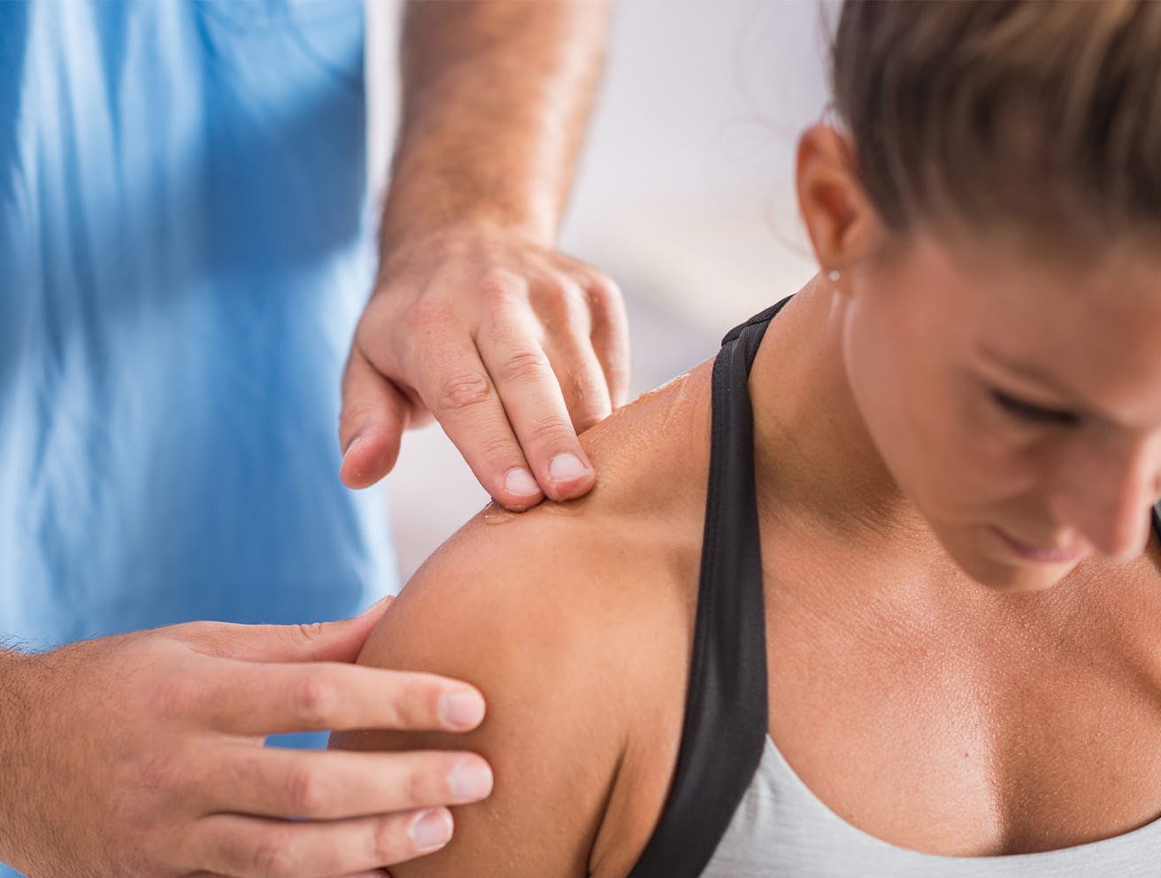 nurse touching a woman's shoulder