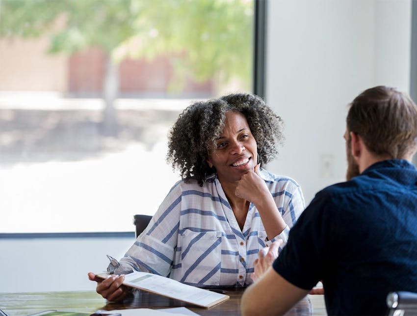 man and woman having a conversation at a table
