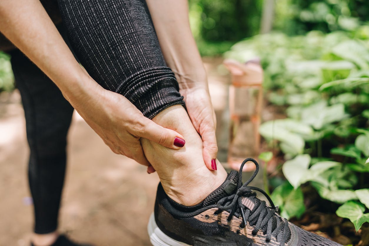 woman holding her ankle