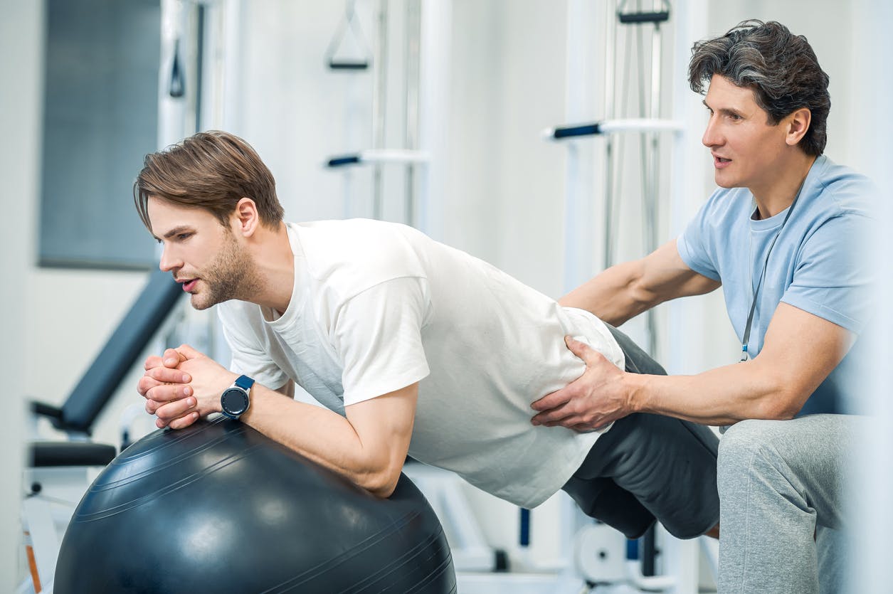 man getting therapy at gym