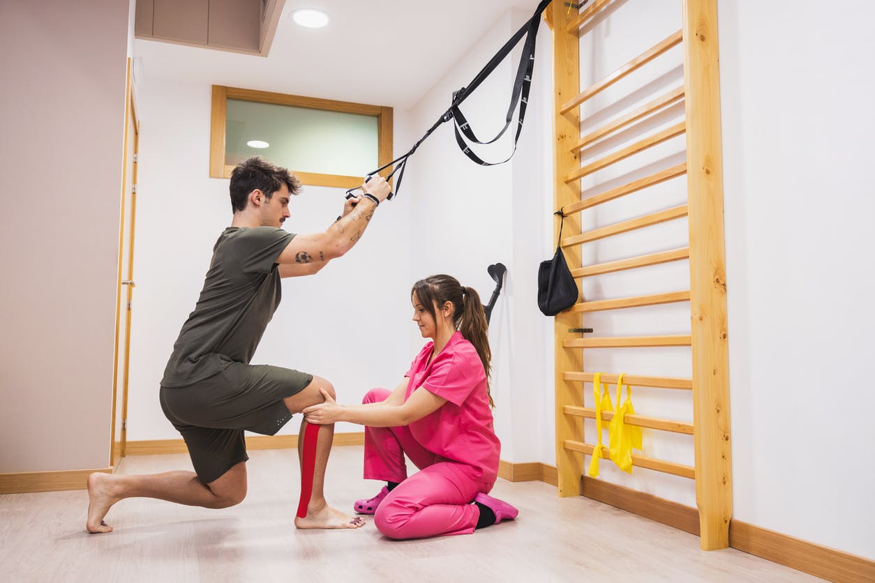 man doing sports medicine with female guidance