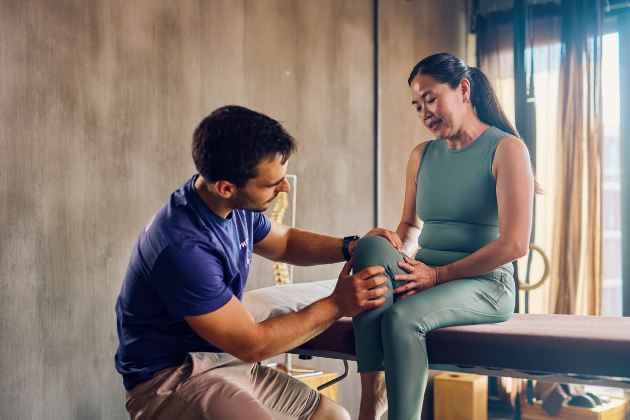 woman in green shirt receiving physical therapy