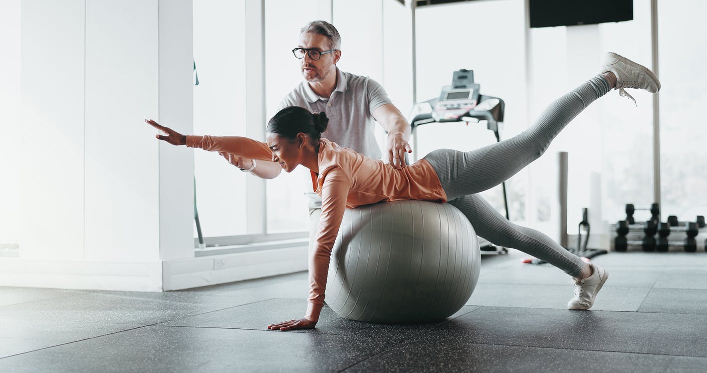 woman receiving therapy on ball