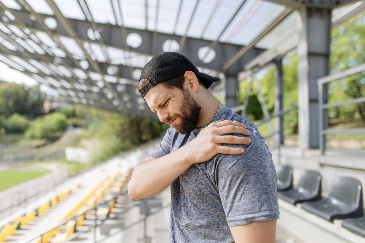man experiencing pain in arm