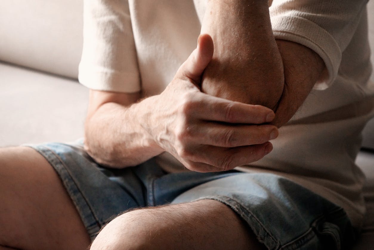 person holding their elbow