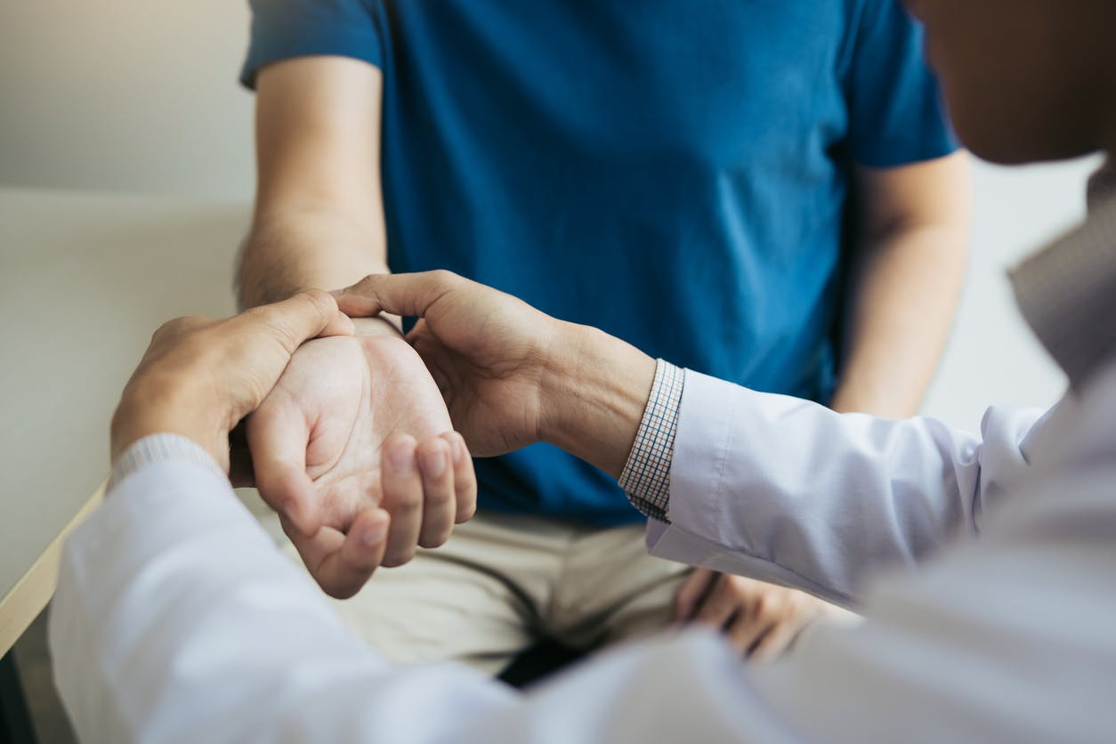 person getting their wrist examined