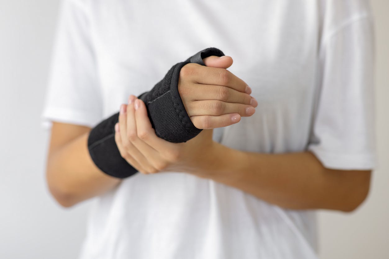 person holding injured wrist