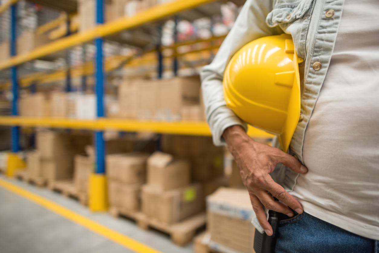 person holding yellow construction helmet
