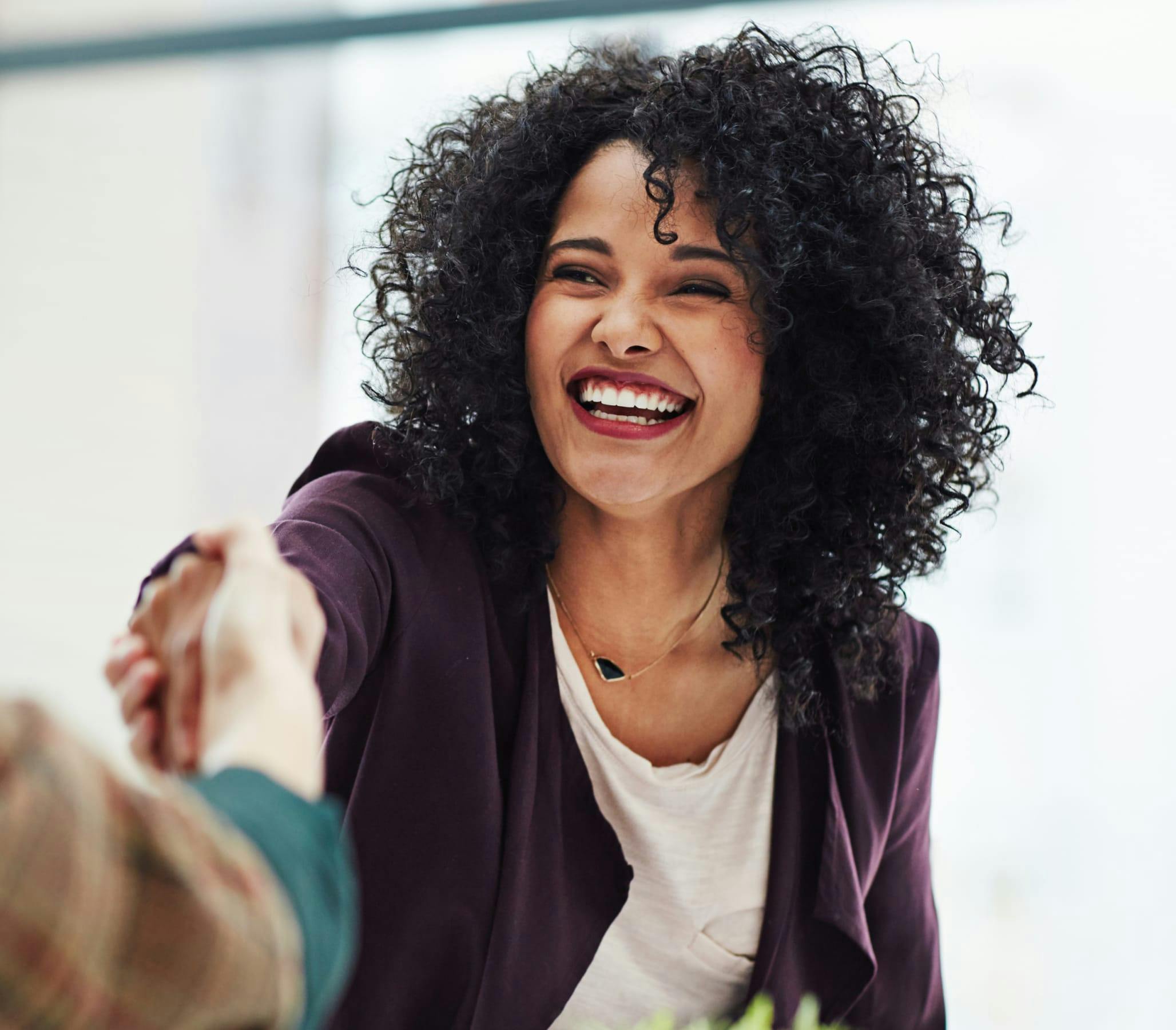 Woman smiling and shaking hands