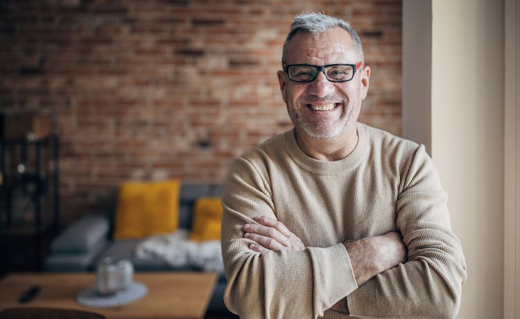 older man crossing his arms