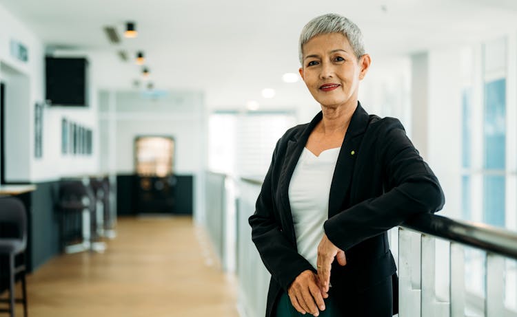 lady in black jacket posing on stair railing