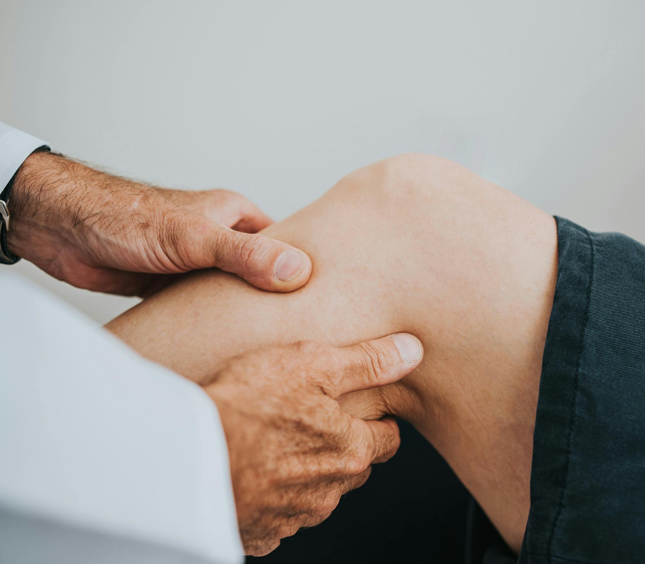 doctor grabbing clients leg below the knee