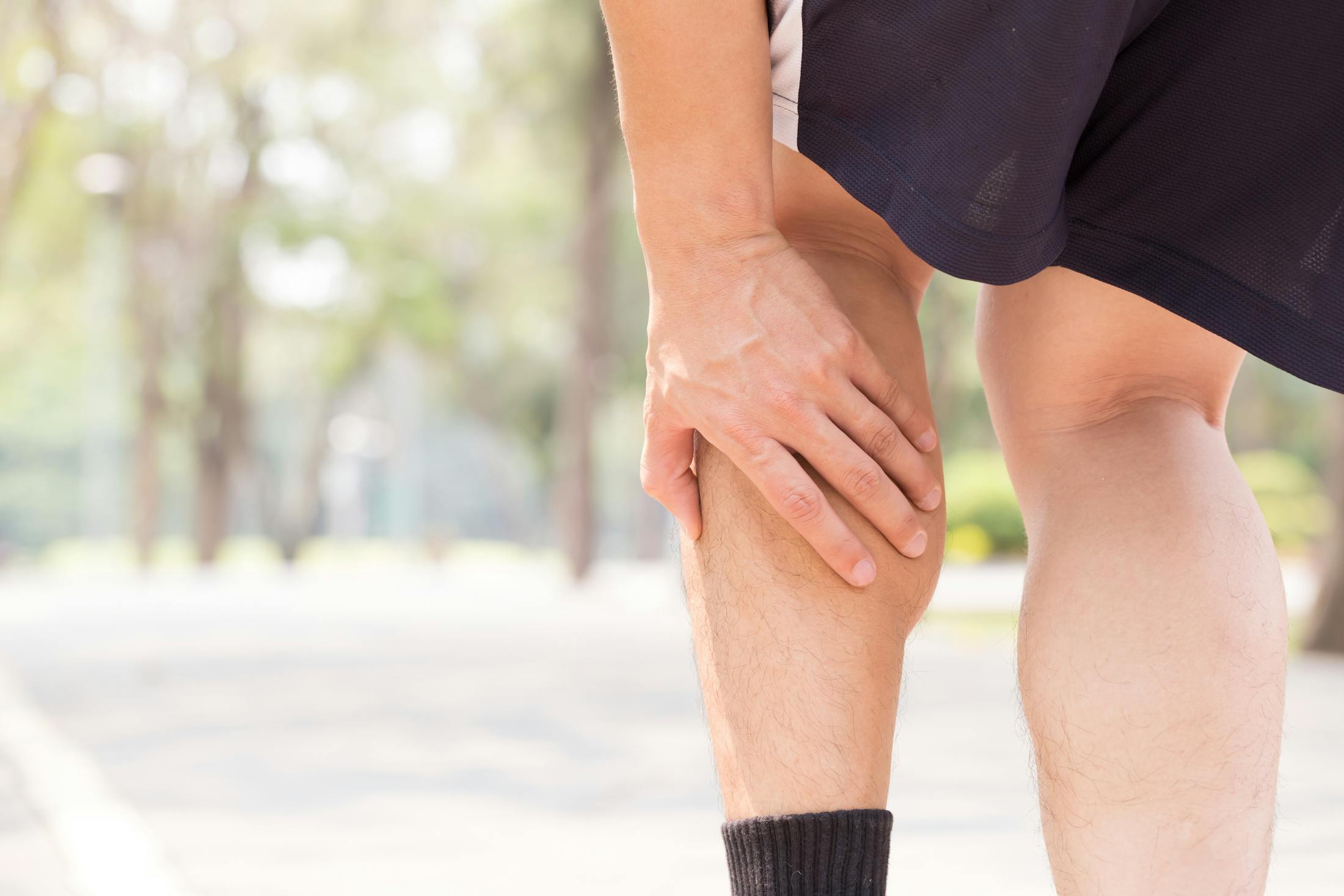 man with leg cramp