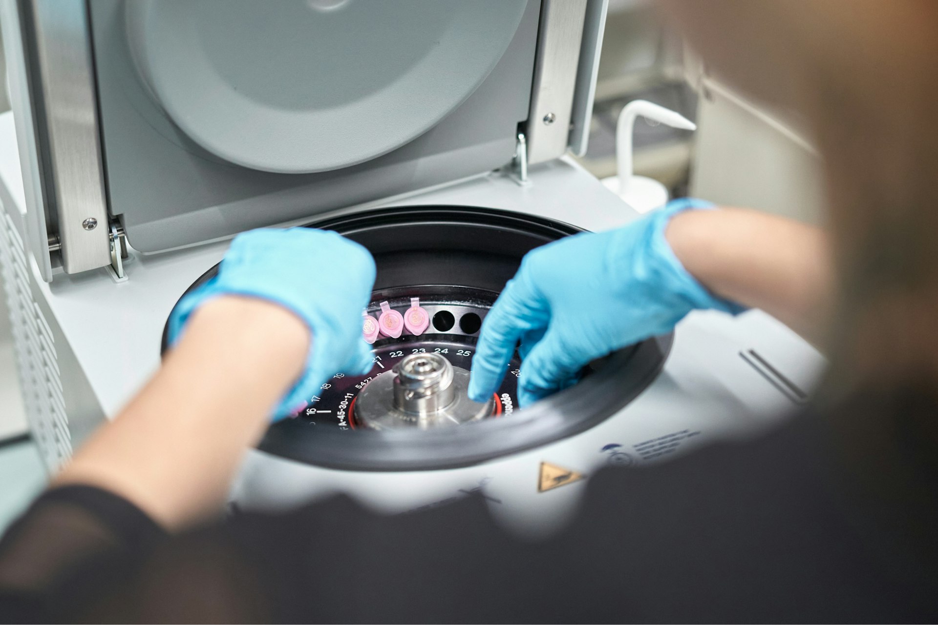 Person working on a centrifuge