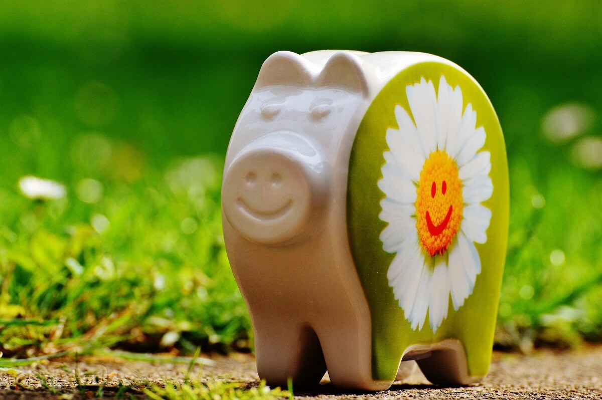Image of porcelain pig ornament with sunflower painted on it.