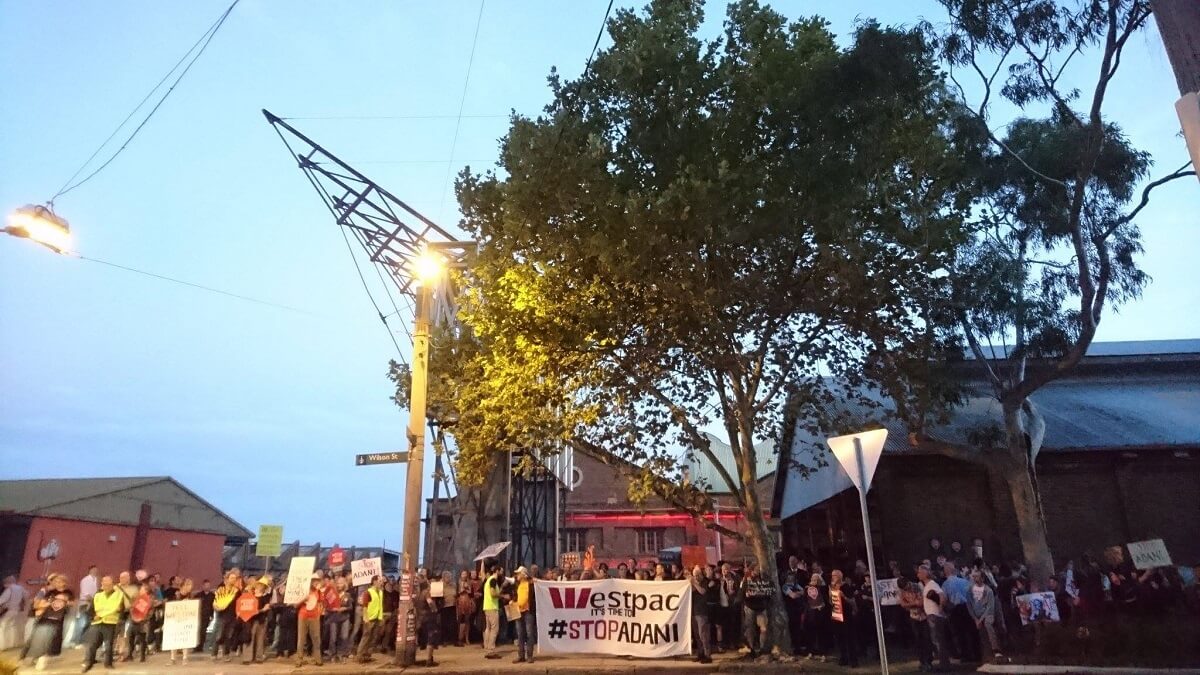 Image of people protesting: Westpac it's time to #STOPADANI