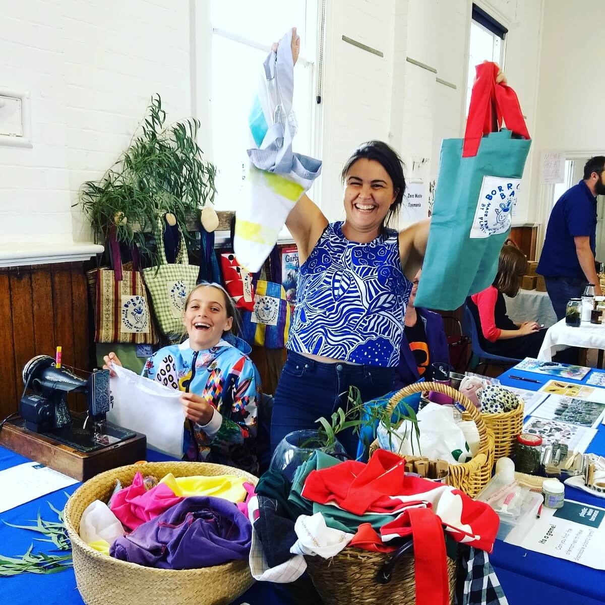 Woman and girl showing a plastic free future