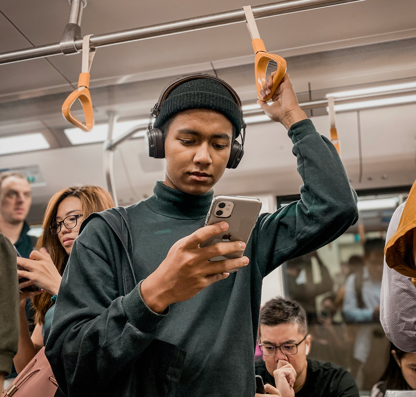 Person standing on train using their phone