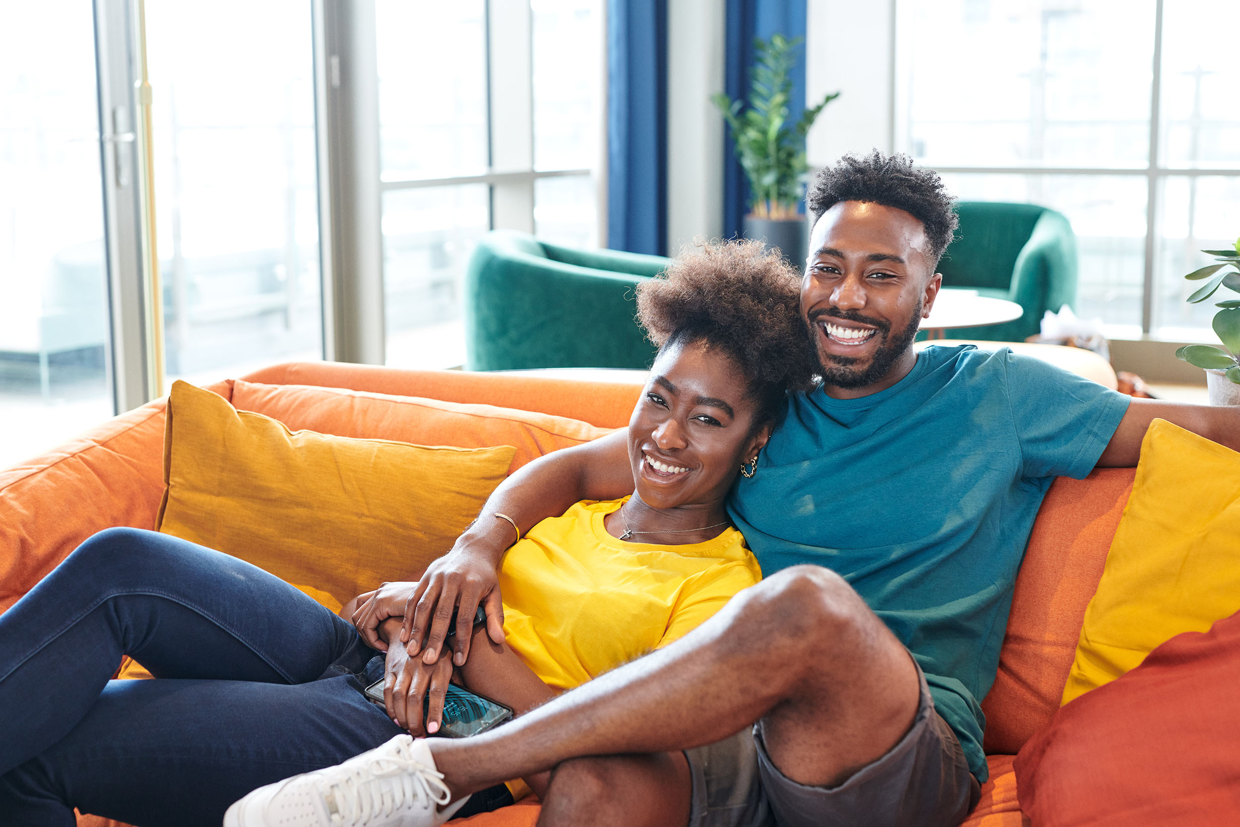 A couple on a sofa in the communal lounge of a Grainger residential building for renters