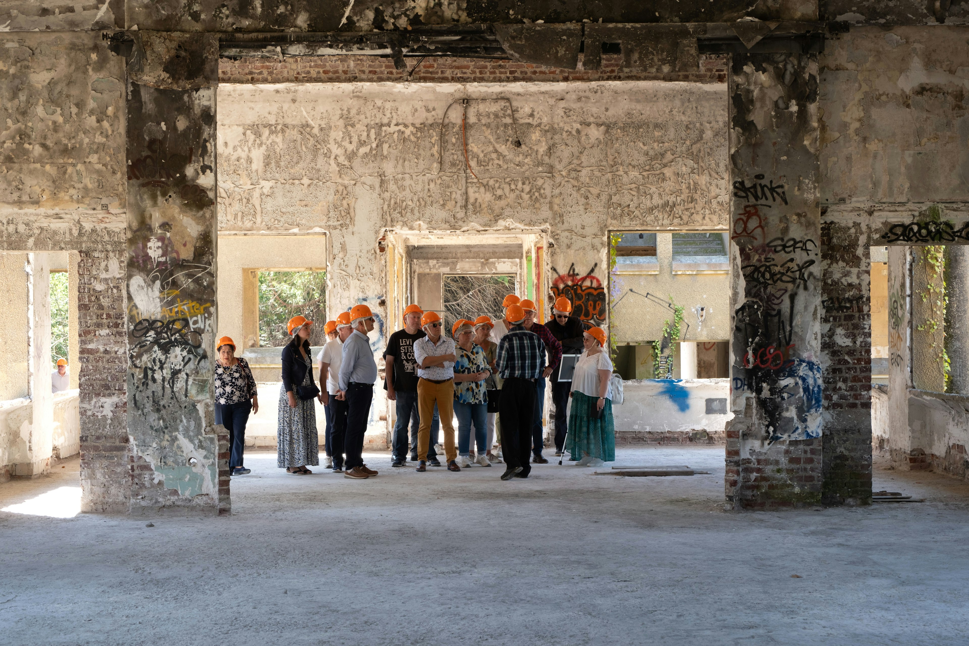 helmet, person, handbag, archaeology, shoe, wall, flower arrangement, pants, glasses, monastery