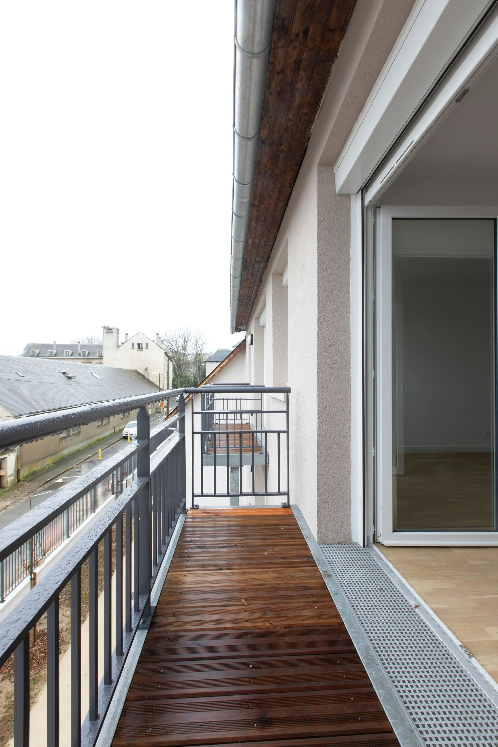 architecture, balcony, building, car, transportation, vehicle, person, railing