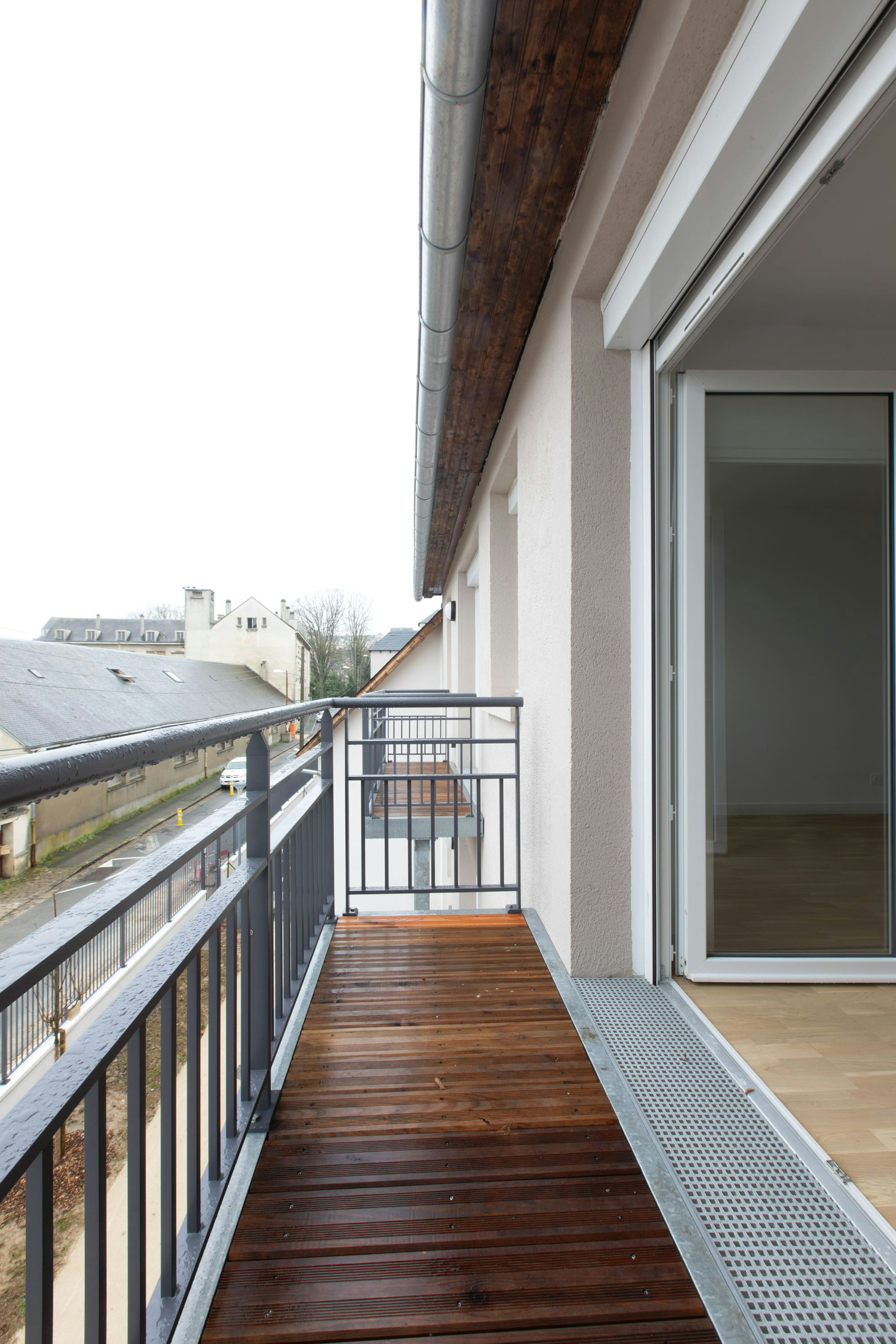 architecture, balcony, building, car, transportation, vehicle, person, railing