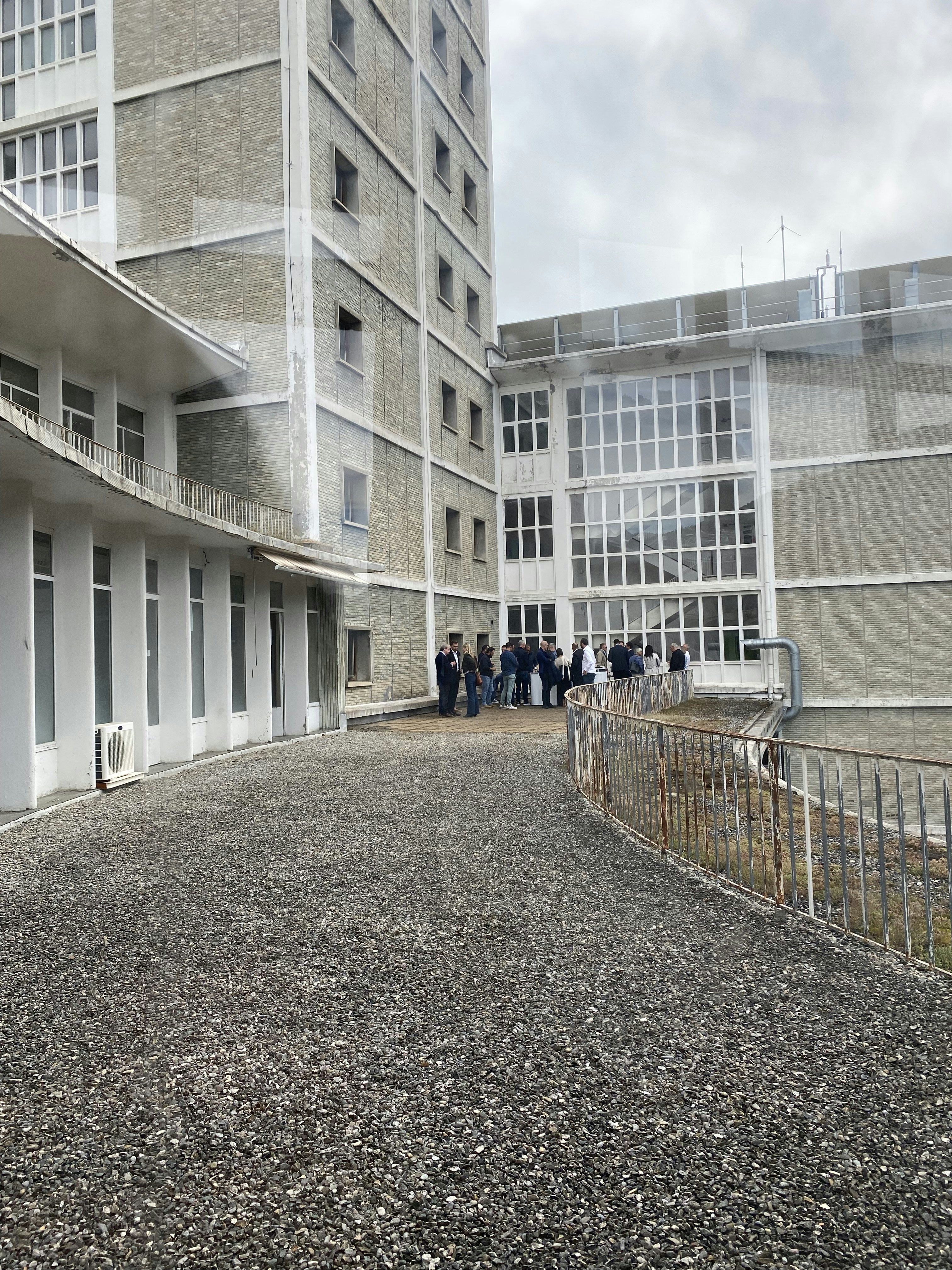 city, urban, road, person, architecture, building, office building, condo, housing, gravel