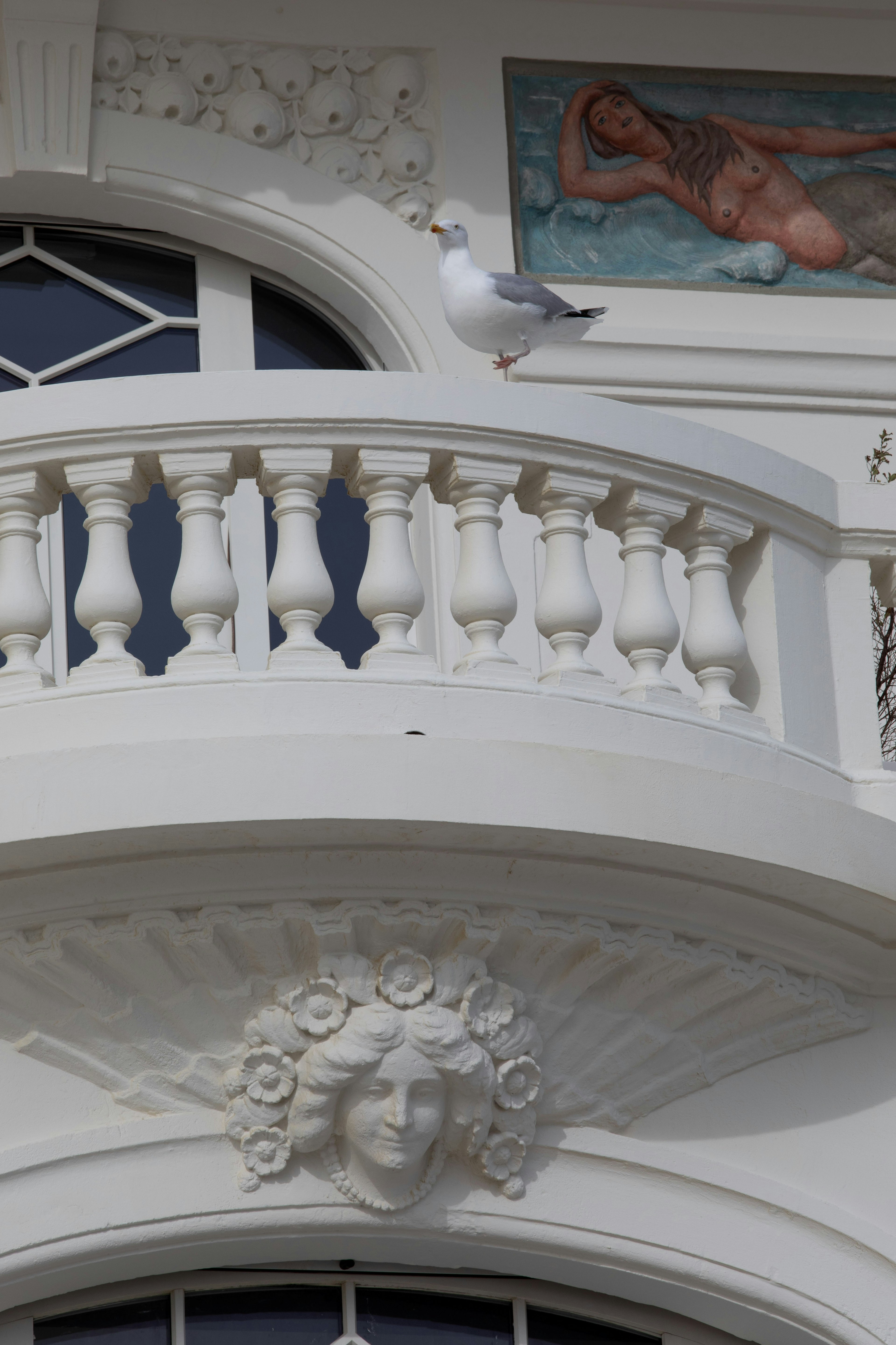handrail, railing, architecture, building, balcony, person, animal, bird, face, seagull