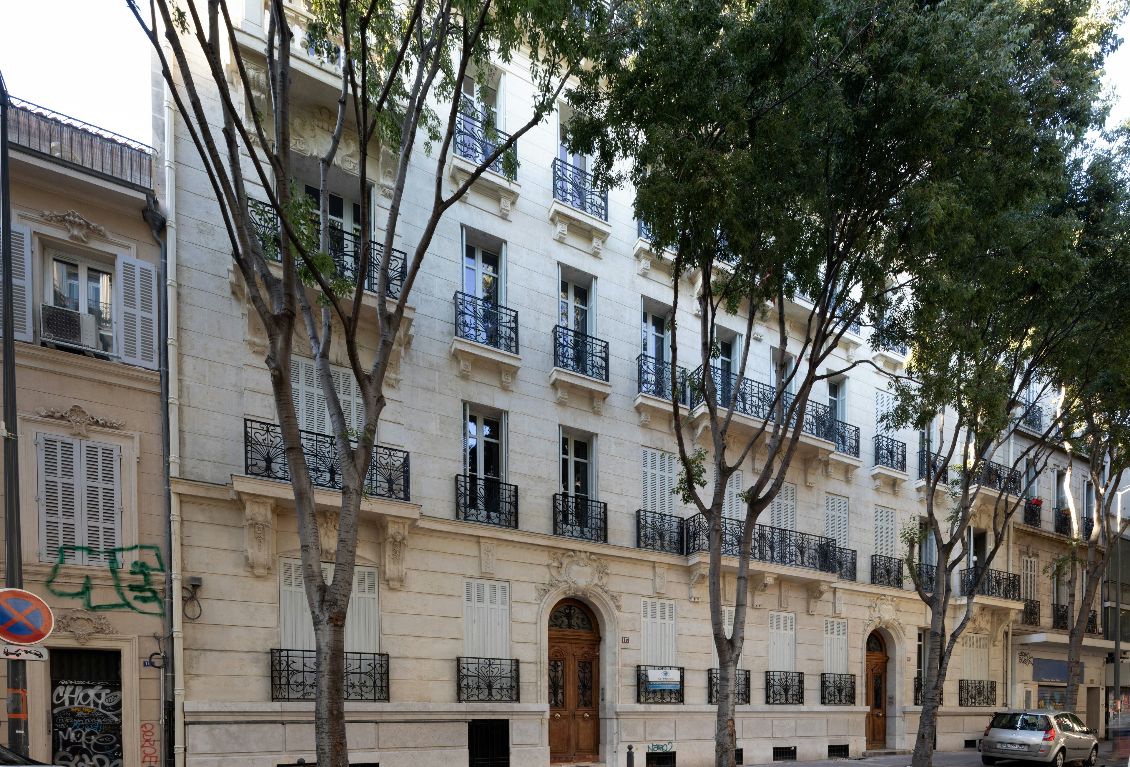 city, neighborhood, urban, apartment building, high rise, tree, condo, car, street, wall