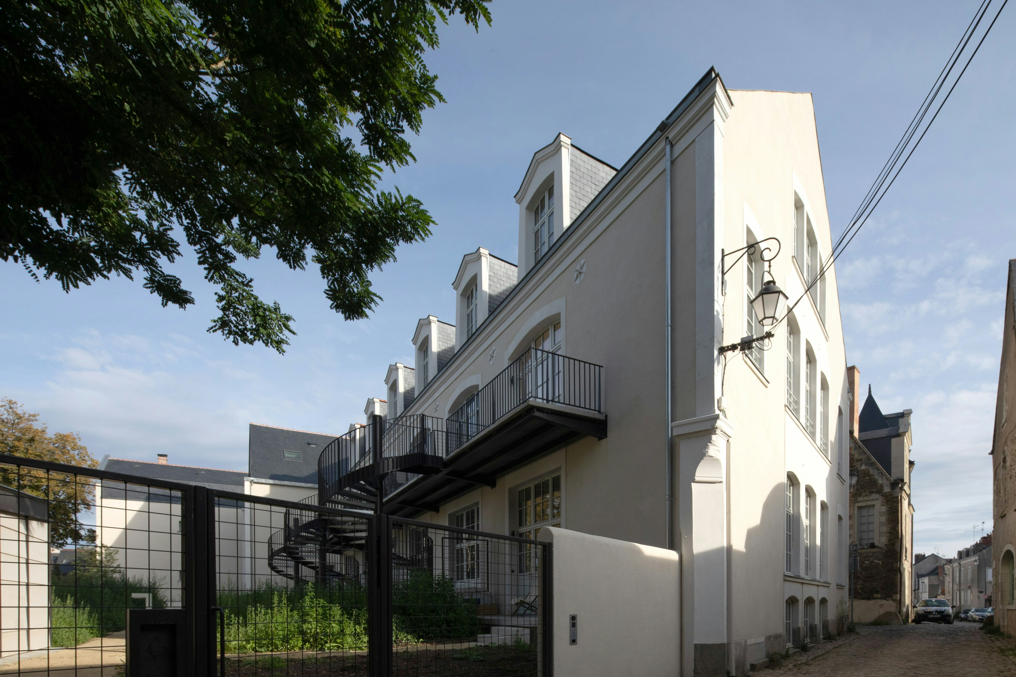 city, road, street, urban, handrail, neighborhood, car, building, railing, office building