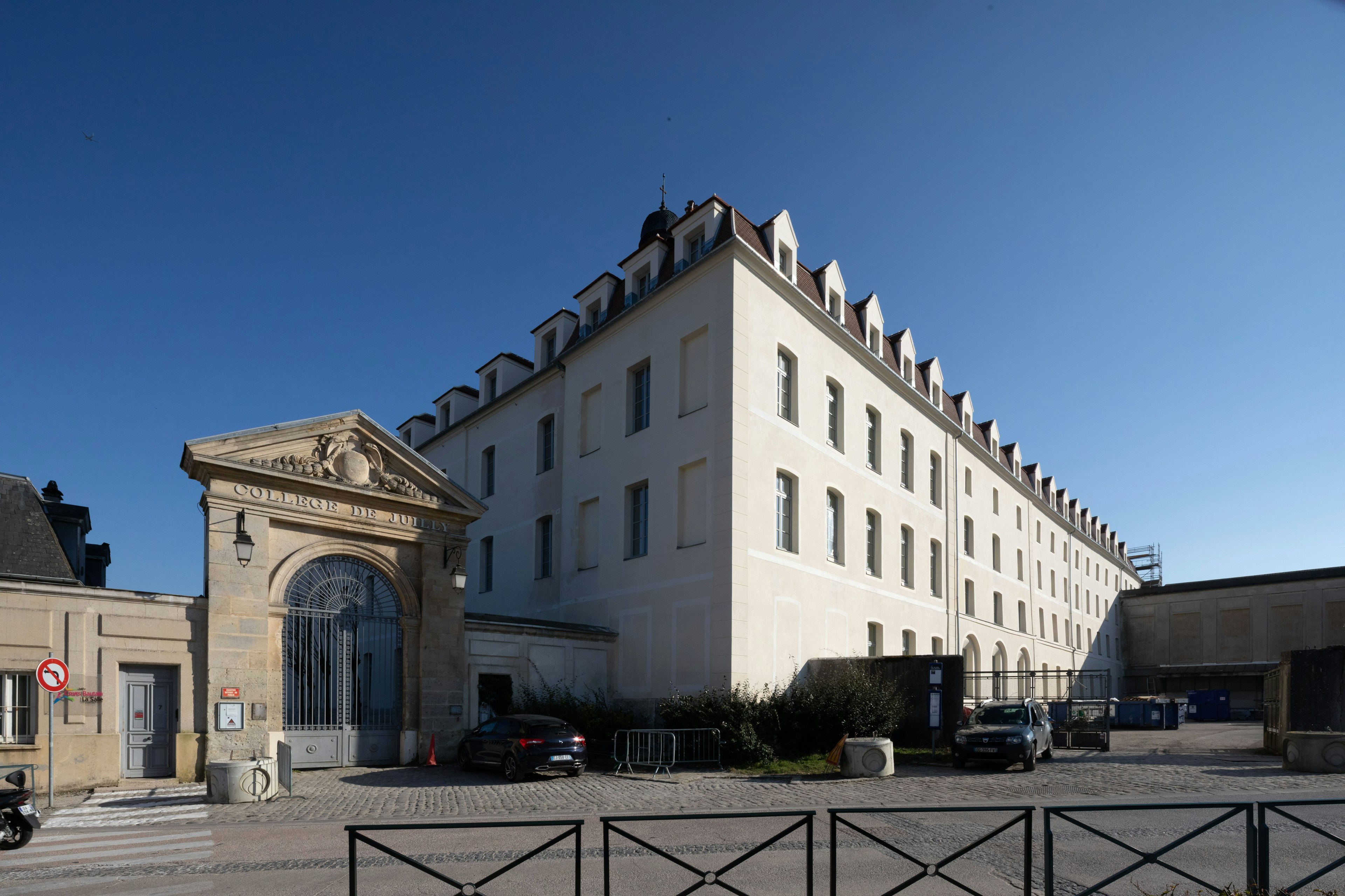 architecture, building, office building, car, transportation, vehicle, motorcycle, city, road sign, symbol
