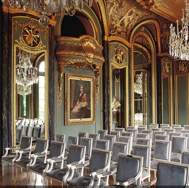 art, painting, chandelier, lamp, indoors, person, room, waiting room, chair, furniture