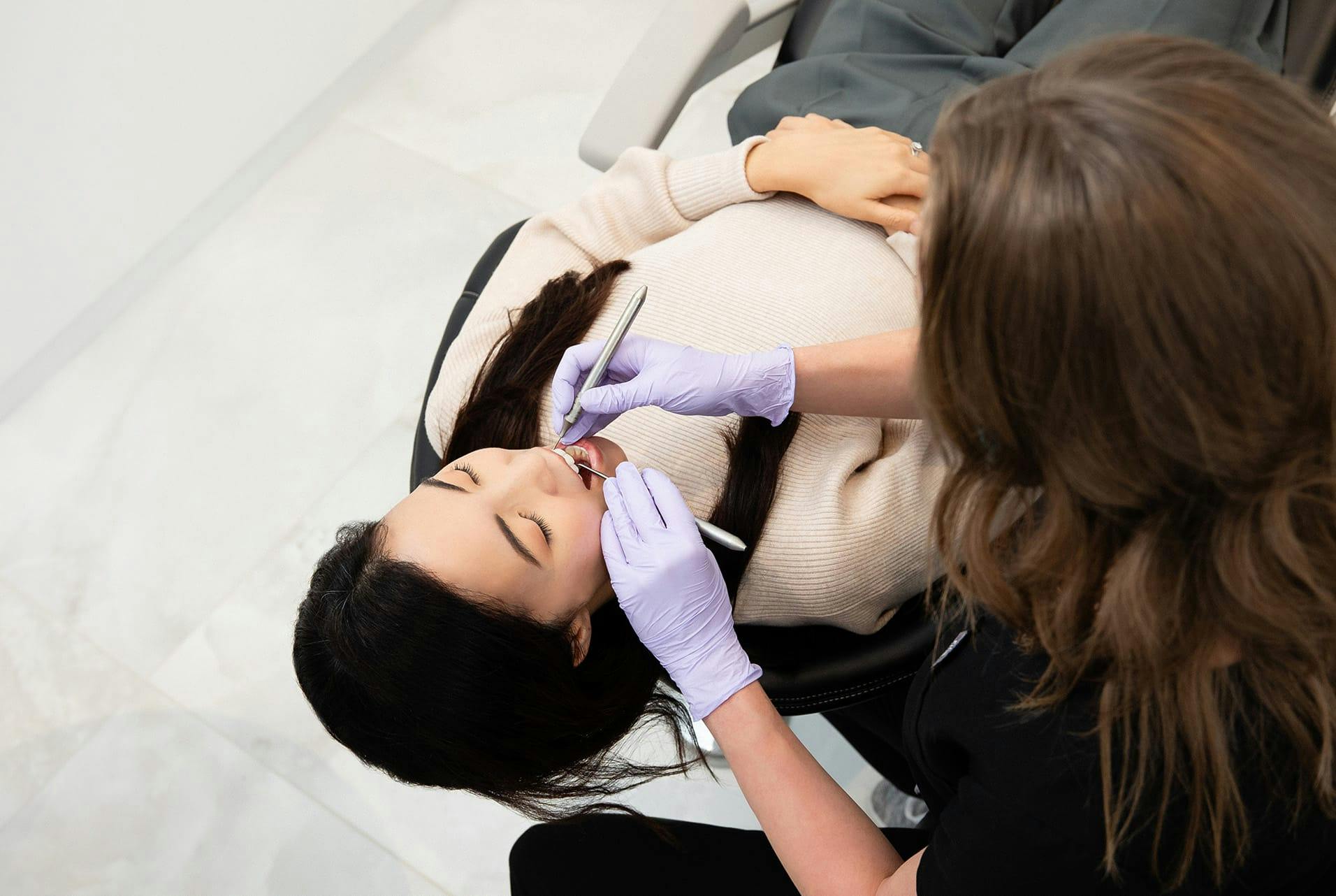 patient getting her teeth checked
