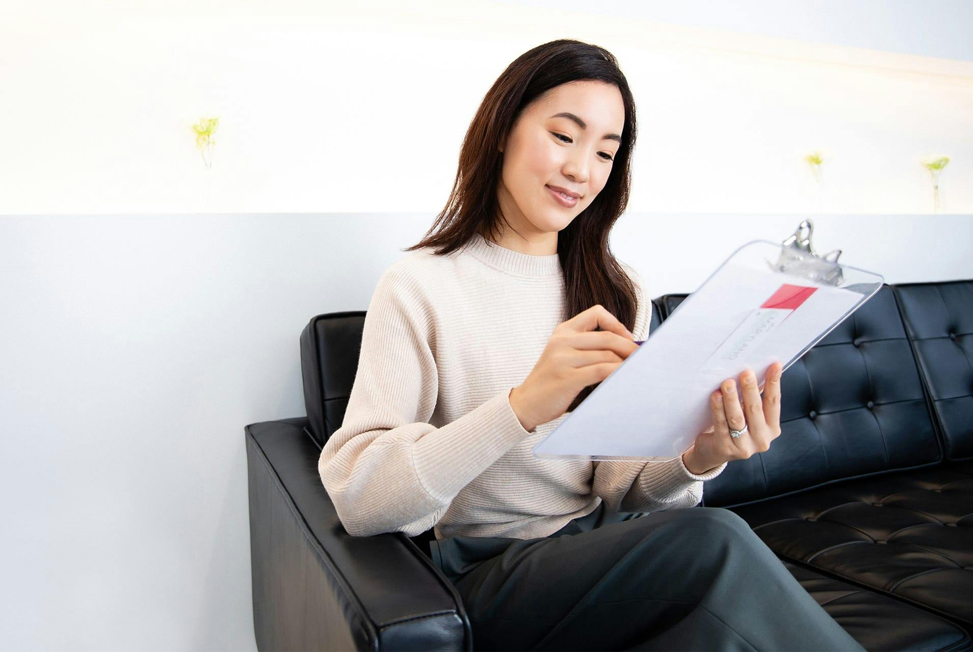 patient writing on a clipboard